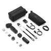 A DJI drone accessories kit laid out on a white background, including two black soft carrying cases, a drone body, batteries, cables, a microphone wind muffler, small accessories, and a remote.