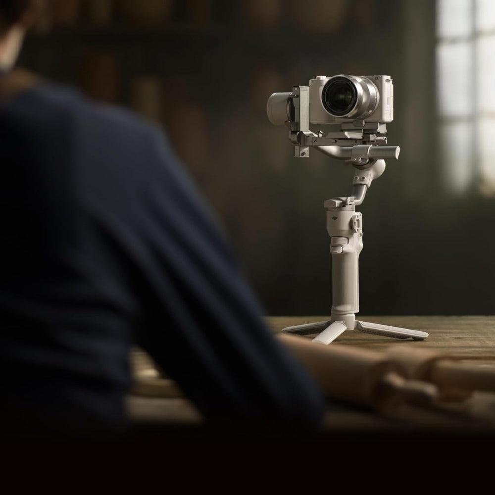 DJI RS 4 Mini Gimbal Stabilizer for cameras, showcasing its compact design and adjustable stabilizing arms.