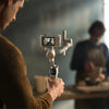 DJI RS 4 Mini Gimbal Stabilizer for cameras, showcasing its compact design and adjustable arm for smooth video capture.