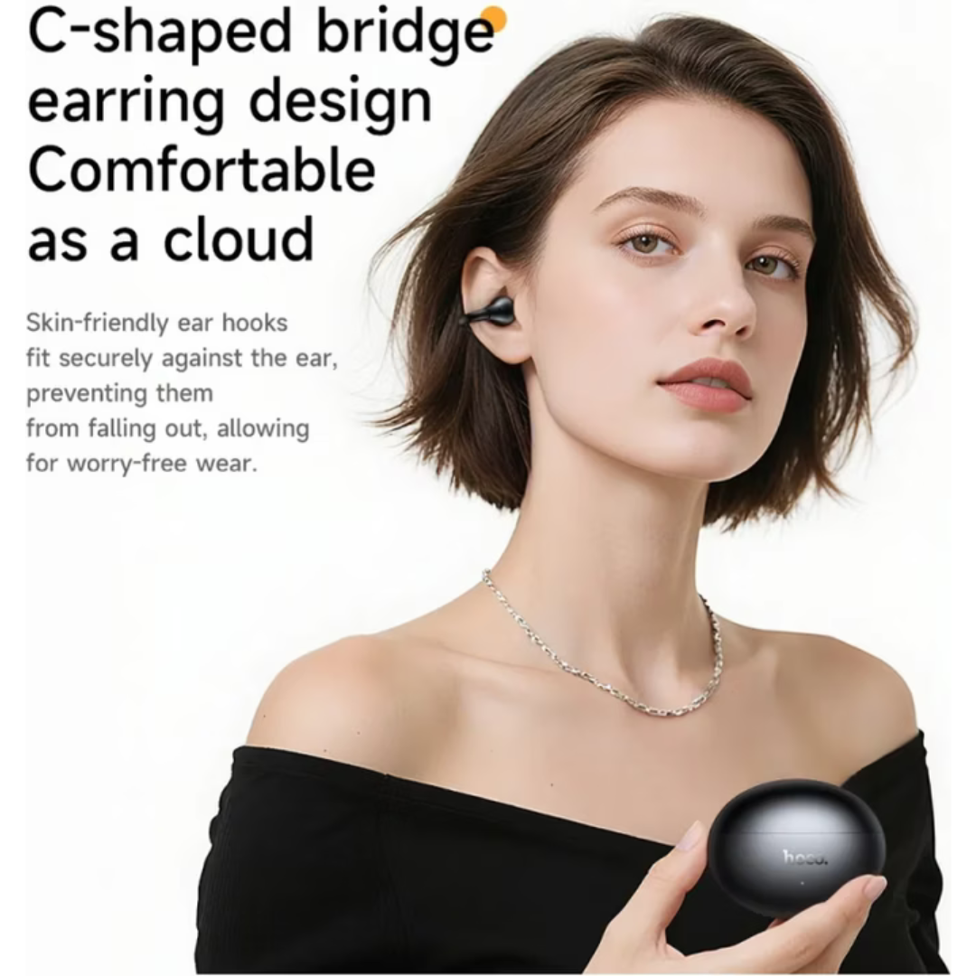 A woman wearing a black wireless earbud and holding its charging case, with promotional text highlighting the C-shaped bridge earring design and comfortable cloud-like fit.