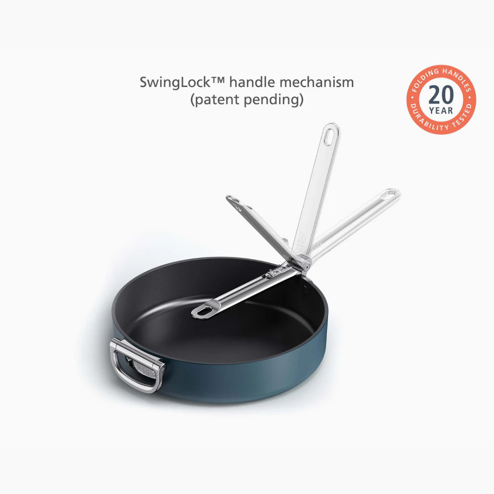 Joseph Joseph blue non-stick 28cm sauté pan with lid and folding handle, showcasing a sleek design and practical features.