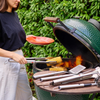 Joseph Joseph GrillOut™ 3-piece stainless-steel BBQ turner, tongs, and fork set on a wooden surface.
