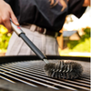 Joseph Joseph GrillOut stainless-steel BBQ cleaning brush with an extending handle, featuring durable bristles for effective cleaning.