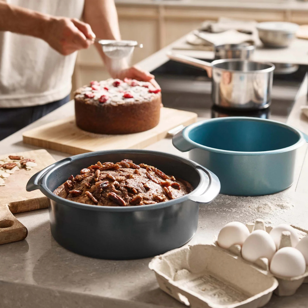Joseph Joseph Nest Bake non-stick round cake pan set with two blue pans, ideal for baking and easy release.