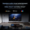 Living room setup with a large TV displaying a concert, featuring Dolby Vision and Atmos logos.