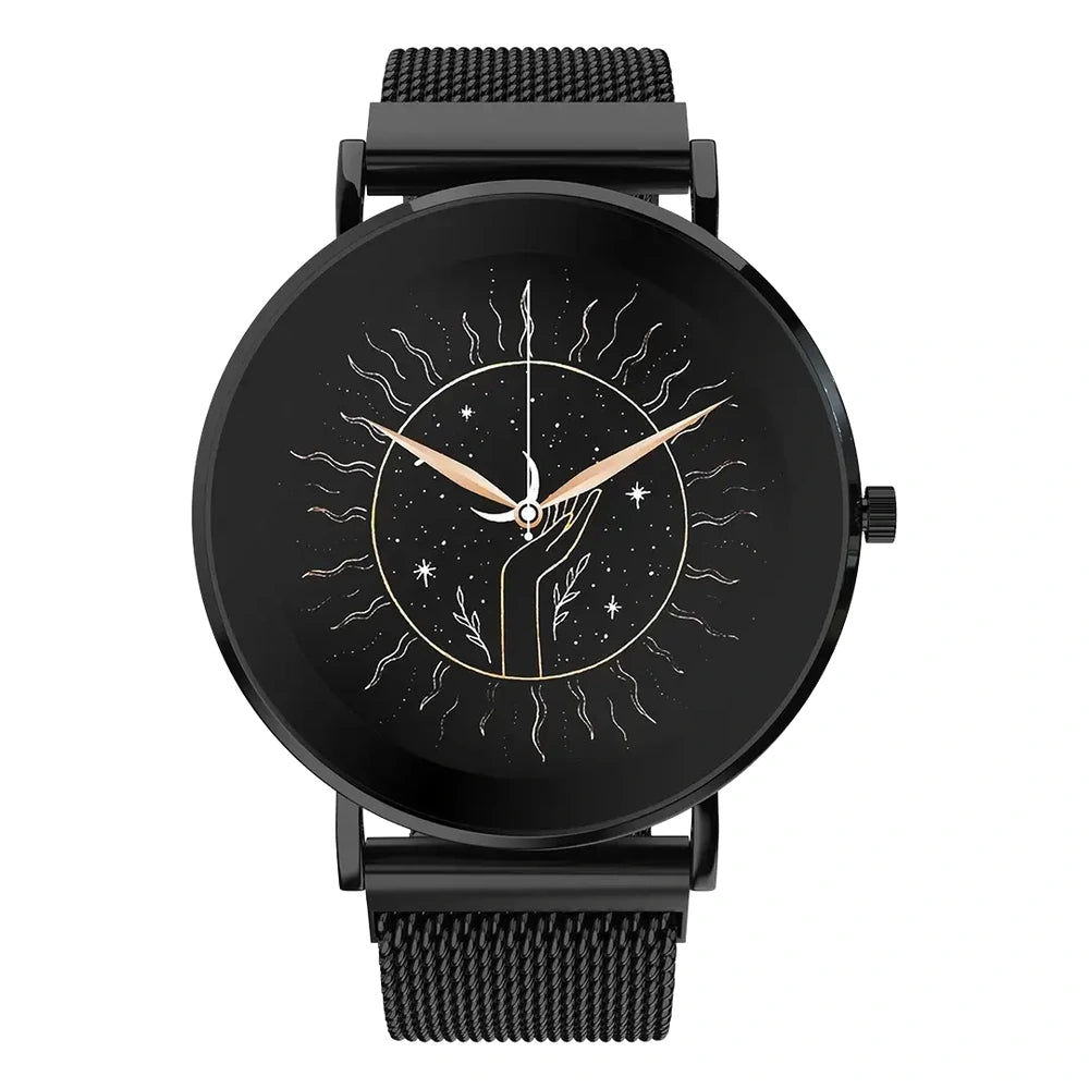 A round analog wristwatch with a black mesh strap, black case, and a black dial featuring a celestial sunburst design with gold-toned hands and small star details.