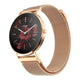 A rose gold women's watch with a mesh metal band, featuring a black round dial decorated with a red floral pattern and the brand name 'noise'.
