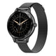 A black smartwatch with a round glossy bezel, black mesh strap, and a custom black watch face featuring gold hands, a central branch, and white star details, shown on a plain white background.